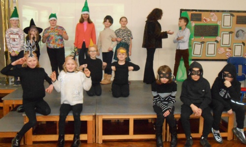 Children on stage in costumes for Hansel and Gretel